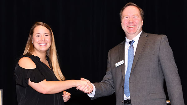 Two people shake hands at the ceremony