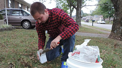 A man examines soil