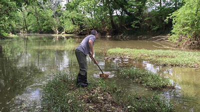 A person works in a local watershed